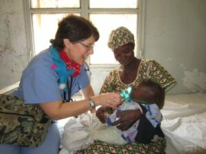 Laura Delany ministers to child in Mali village