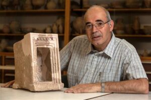 Yosef Garfinkel, an archaeologist at the Hebrew University of Jerusalem, shows off a stone shrine model that was found during excavations at Khirbet Qeiyafa (photo courtesy Hebrew University of Jerusalem) 