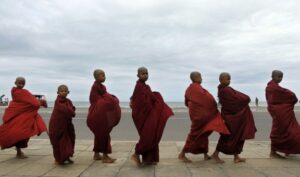 A group of Sri Lankan young Buddhist monks parade, seeking alms in Colombo, Sri Lanka.