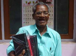 Kunjukunju "Mr. K" with Bibles