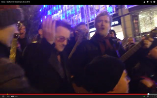 Bono lifts hand in reverence