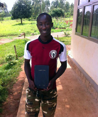 Boy holds Bible that survived