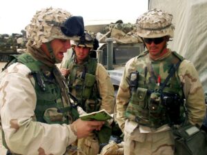 Chaplain Cash leads men in prayer in Kuwaiti desert