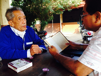 Christopher reading Bible with Duch in prison