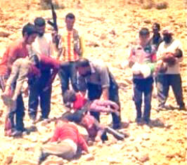 Kurdish men carry the bodies of children who died after being driven from their homes with nothing to eat or drink