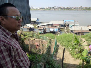 Paul Ai surveys boats where Vietnamese immigrants live