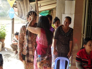 Ruth Ai prays for a patient