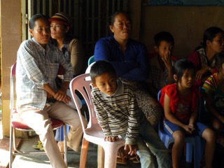 Children and their parents wait and watch in the same room where Dr. Yamamoto works