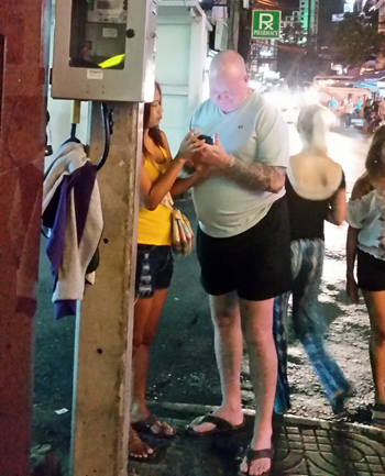 Man solicits young Asian woman on the street