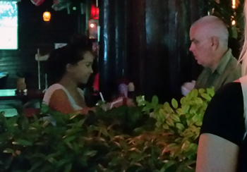 Older man with young girl at bar