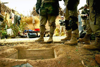 Soldiers stand near entrance to Saddam's hiding place