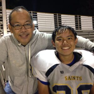 John Mira, with his son, Jelove (short for Jesus Loves), a student at the Lighthouse Christian Academy in Santa Monica.