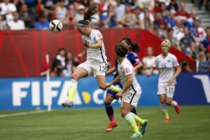 Holiday wins the header against Japan.