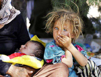 Yazidi girl holds brother