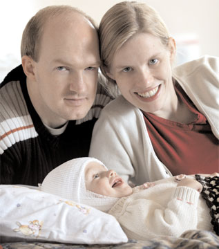 Peter and Nelly Block, with one of the twins Dr. Carson separated surgically when they were joined at the head.