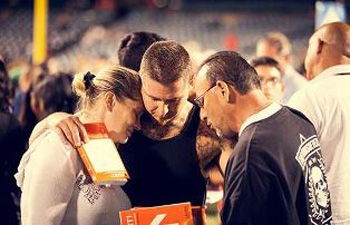 Counselor prays with couple