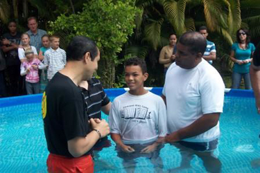 Samuel (right) involved in a baptism