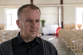 Raeed at temporary church in refugee camp in Erbil (World Watch Monitor)