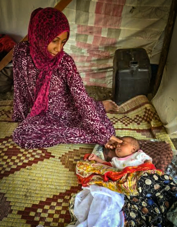 Syrian refugee woman and child from Aleppo, Syria at a makeshift tent camp in Turkey (Christian Aid Mission)