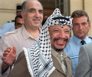 Palestine Liberation Organisation (PLO) chairman Yasser Arafat (C), surrounded by his advisers, including Salah Khalaf aka Abu Iyad (behind Arafat, smiling), addresses media 29 August 1990 in Paris after his meeting with French Premier Rocard. Abu Iyad, who was born to a middle-class family in Jaffa in 1933, was later put in charge of security and intelligence, including counter-intelligence, of PLO. Abu Iyad was assassinated in January 1991 by what PLO sources identified as a bodyguard of the PLO leader Abu al-Hawl, who was also assassinated that night. Reports suggested that the gunman belonged to Abu Nidal's organization, although the PLO has never investigated the assassination. AFP PHOTO PIERRE GUILLAUD (Photo credit should read PIERRE GUILLAUD/AFP/Getty Images)