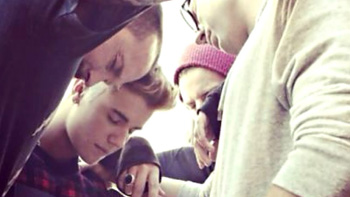 Bieber praying with friends