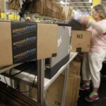Worker prepares an item for delivery at Amazon’s distribution center in Phoenix